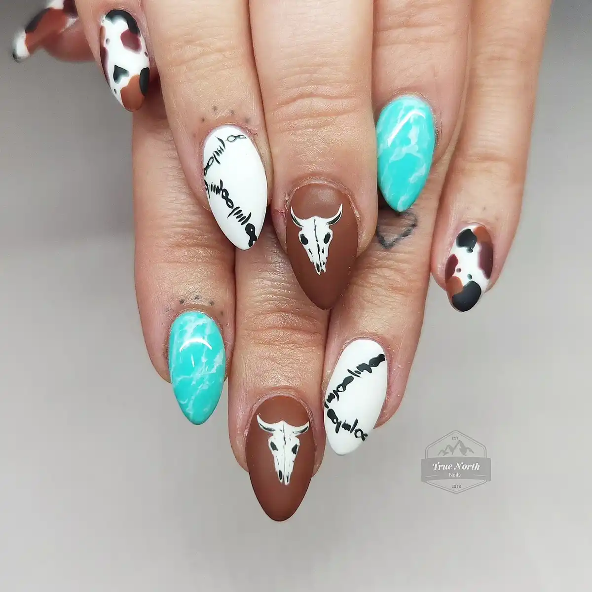 Turquoise marble, cow print, and skull accents