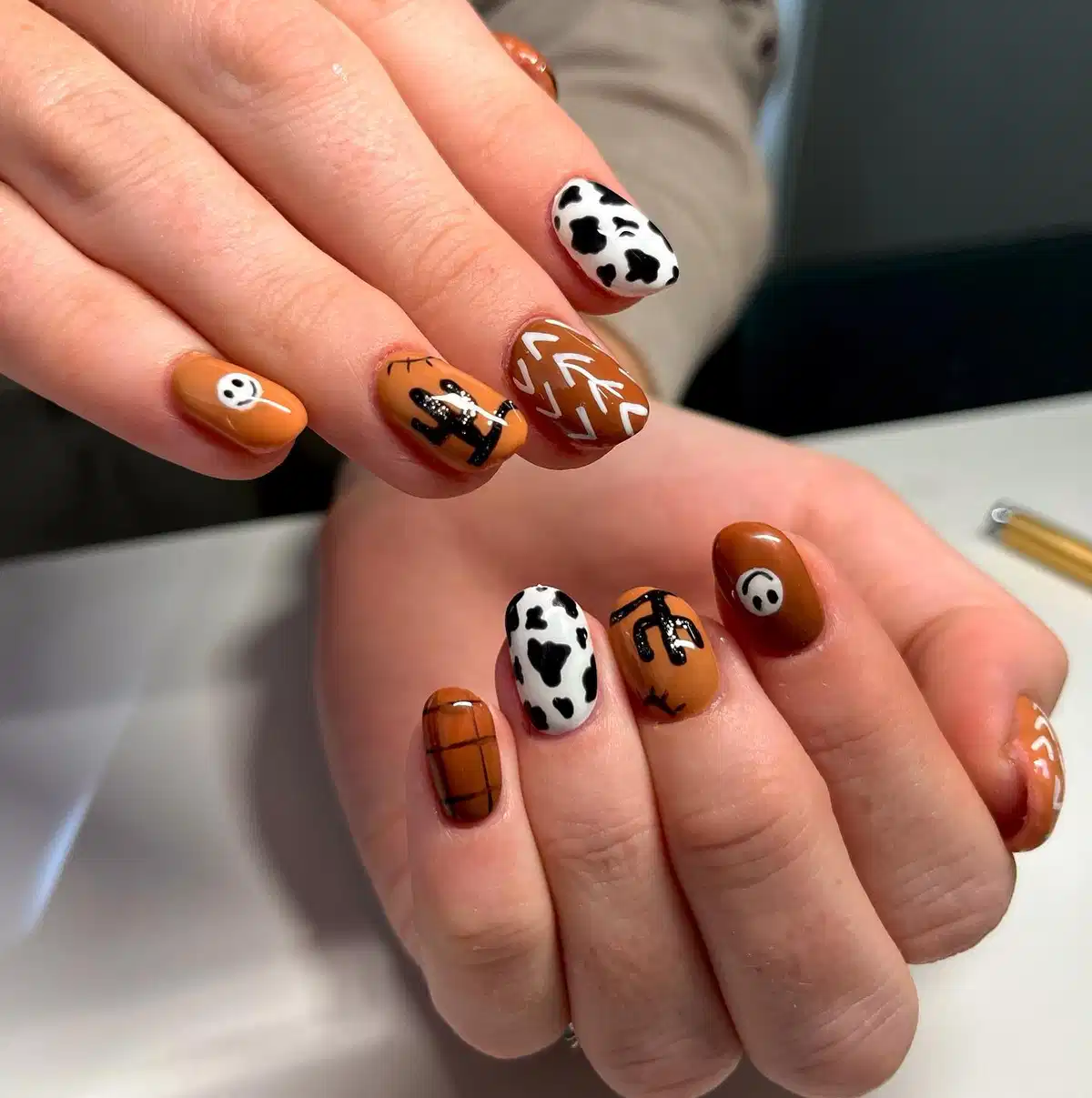 Warm browns with cow print, cactus silhouette, and chevron lines
