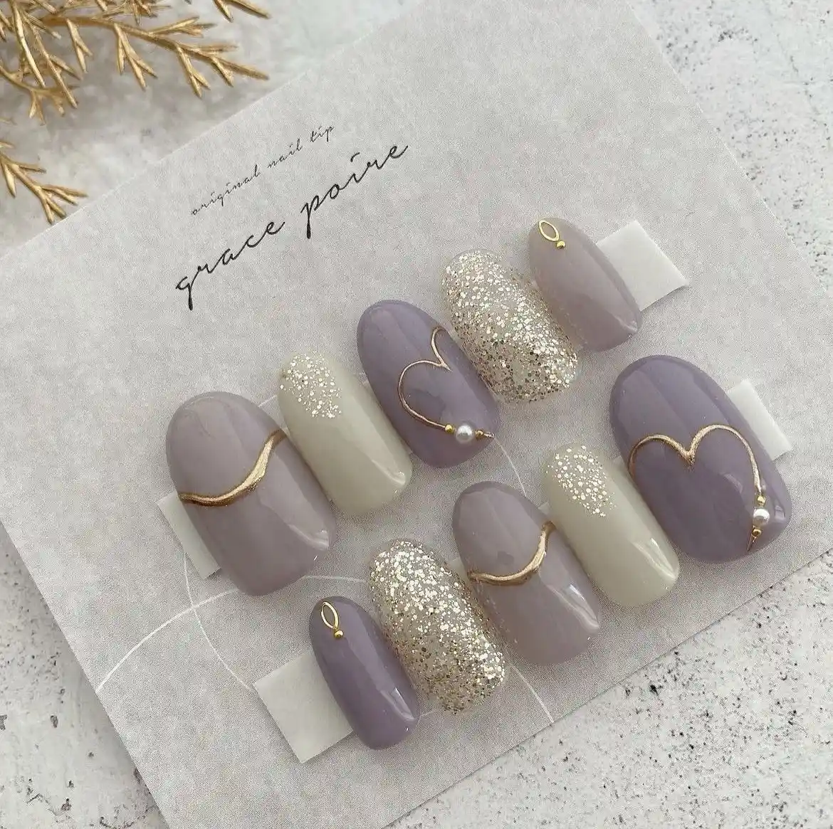 Lavender and cream nails with gold heart outlines and silver glitter accents