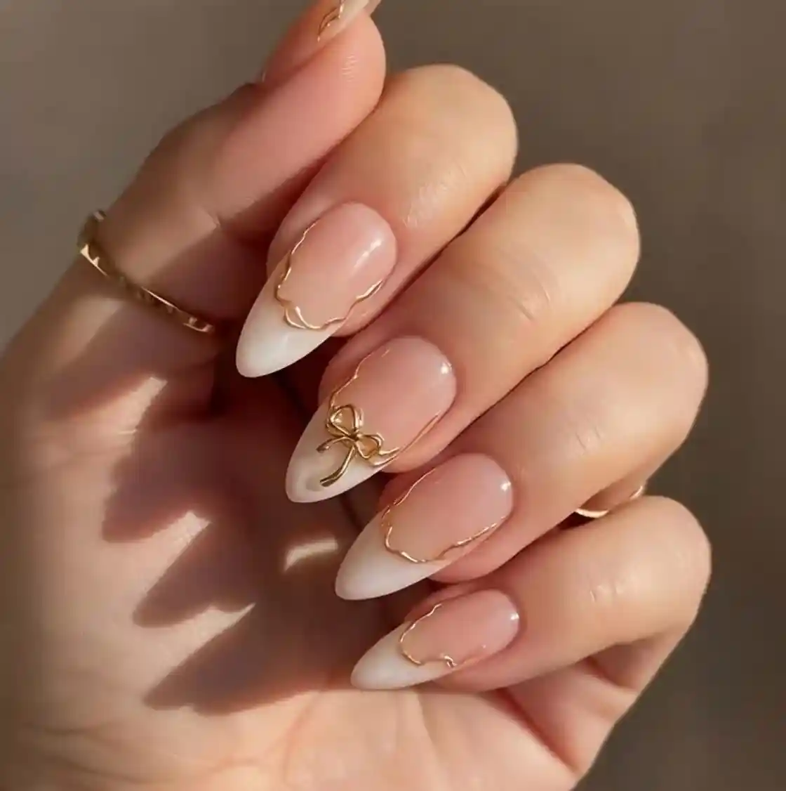 Nude-to-white ombré with gold outlines and bow accent