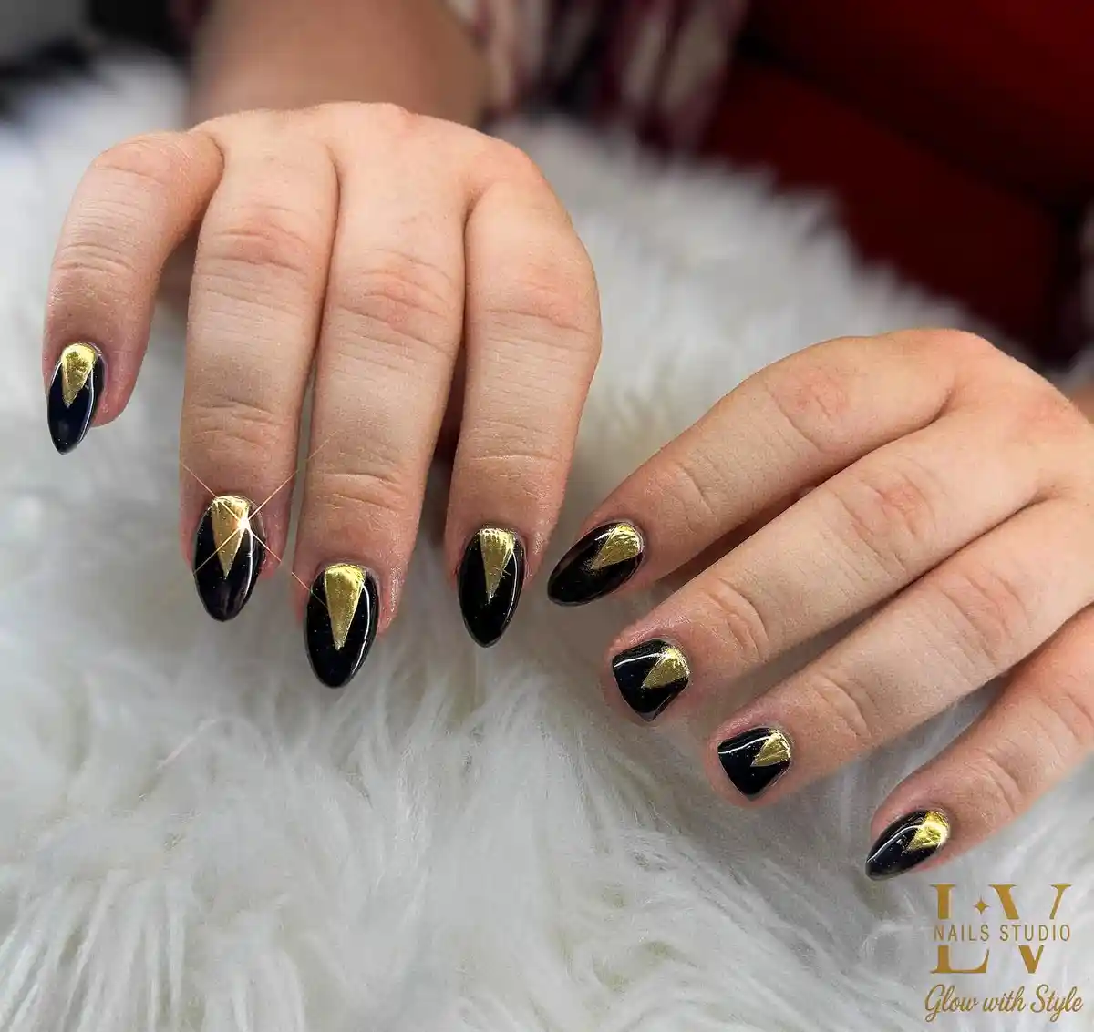 Black nails with gold triangle cuticle accents