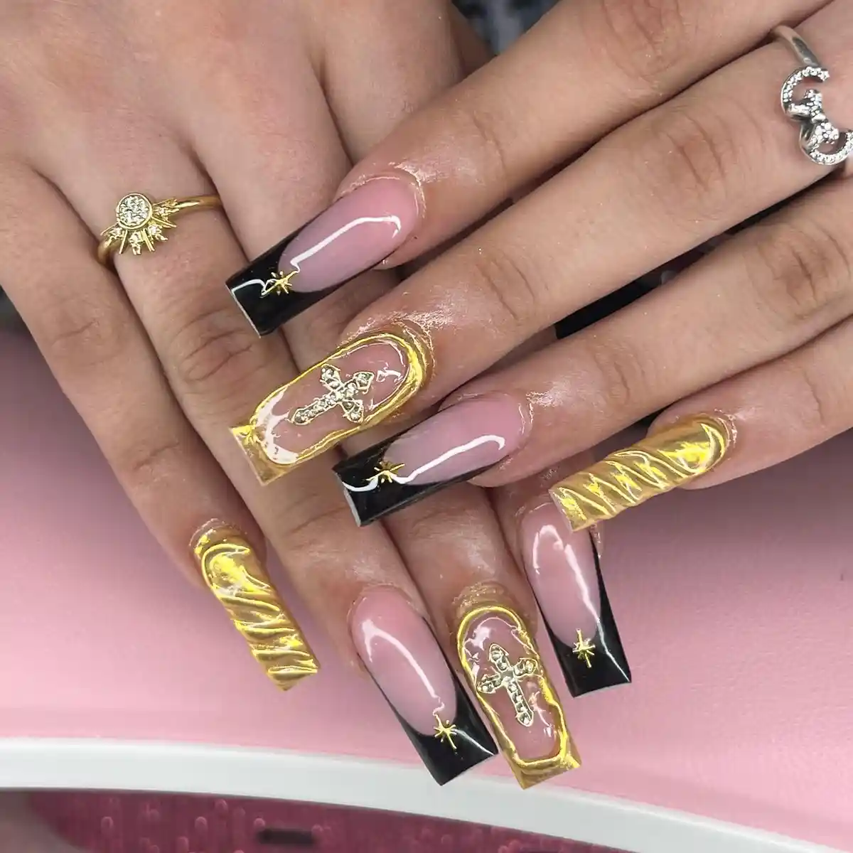 Black French tips with gold stars and gold feature nails