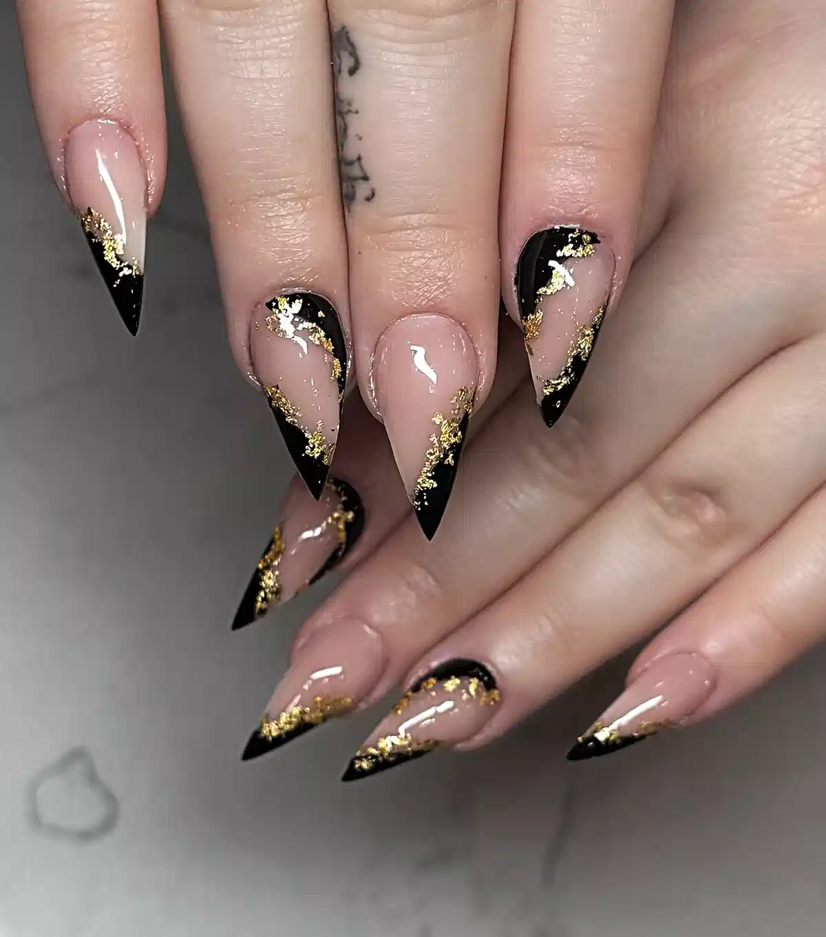 Angled black tips with scattered gold flecks