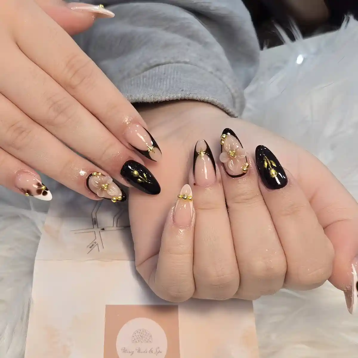 Black and nude mix with floral accents and gold beads