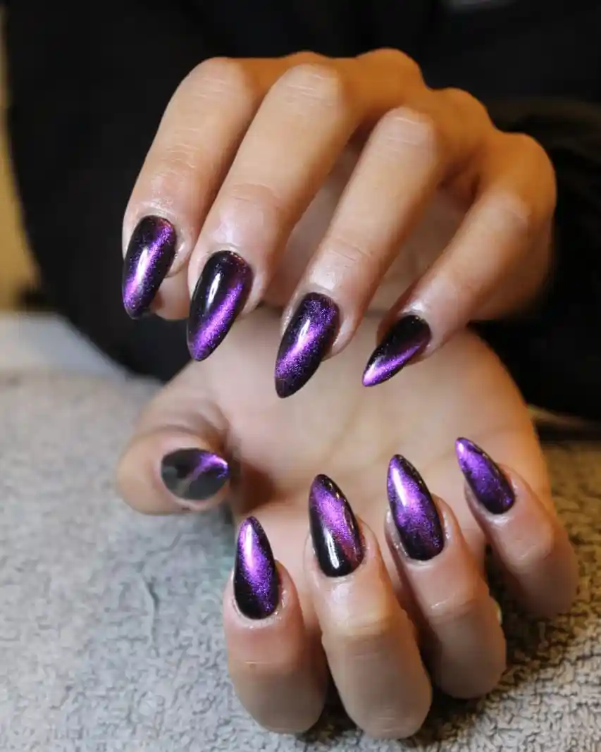 Black nails with centered purple shimmer stripe effect