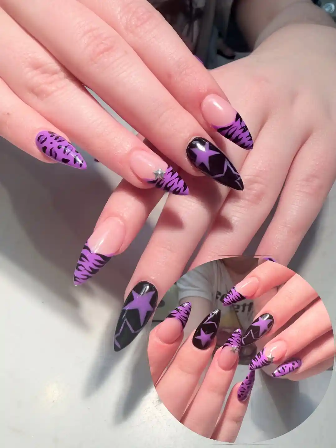 Nude base with purple/black animal-print tips and star accent