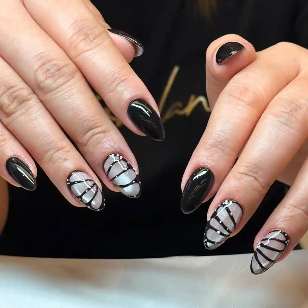 Black almond nails with silver-and-black striped accents