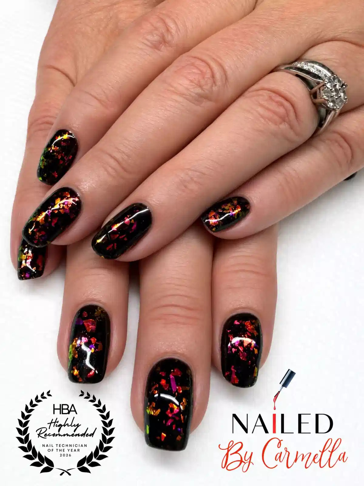 Glossy black nails with multicolor foil-flake effect