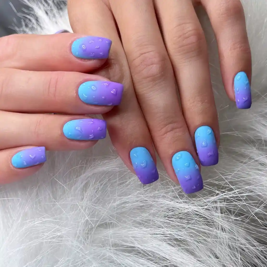 Blue-to-purple ombre with raised droplet effect