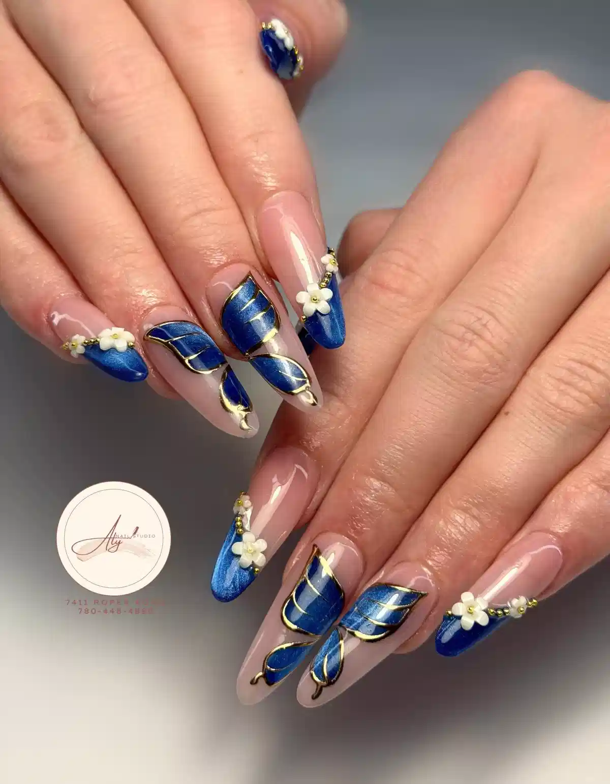 Gold-outlined metallic blue leaf panels with 3D flowers