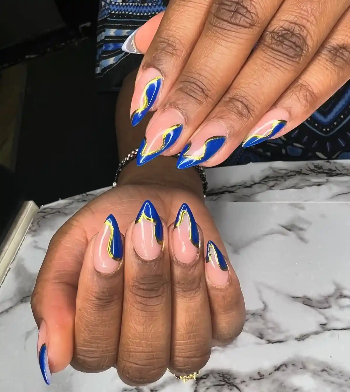 Curved royal blue tips outlined in gold