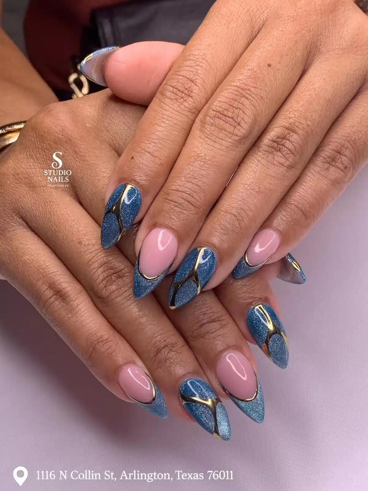 Blue glitter and nude negative space with gold striping