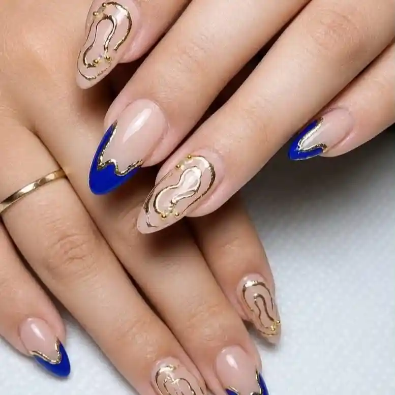Blue French tips with gold outlines and abstract accents