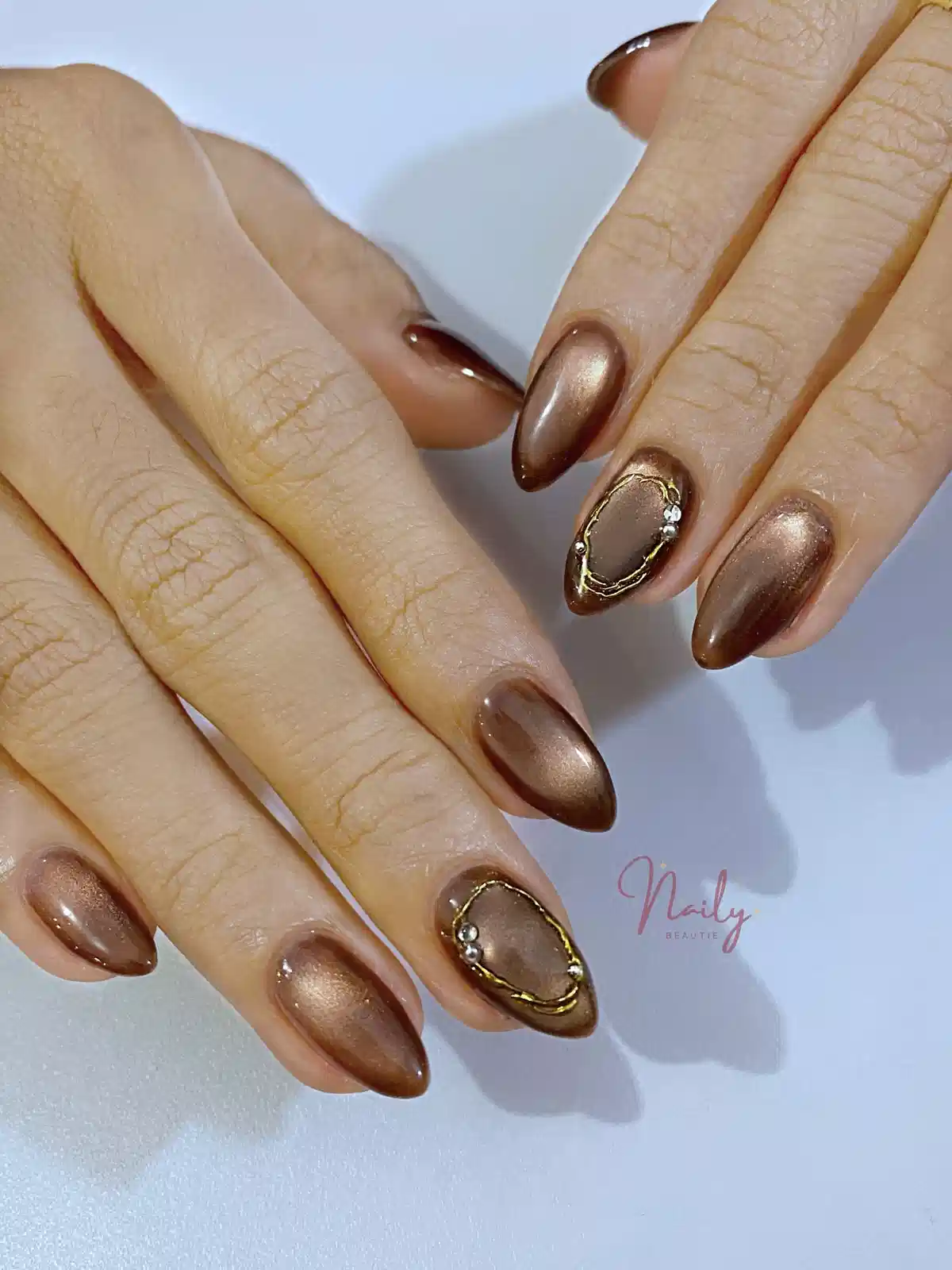 Metallic brown set with irregular gold-framed accent nails