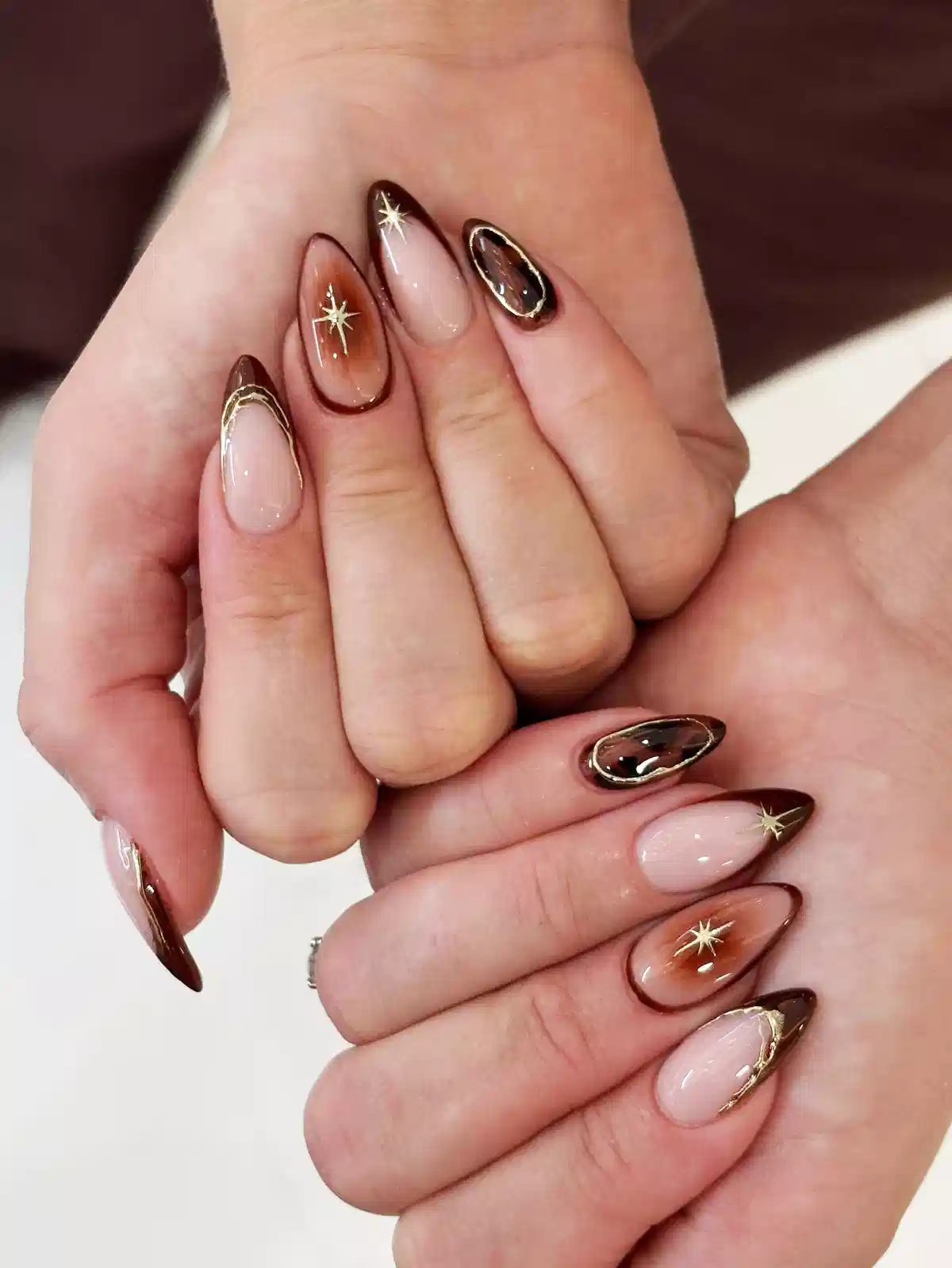 Brown-outlined tips with gold starbursts and gold-edged accents