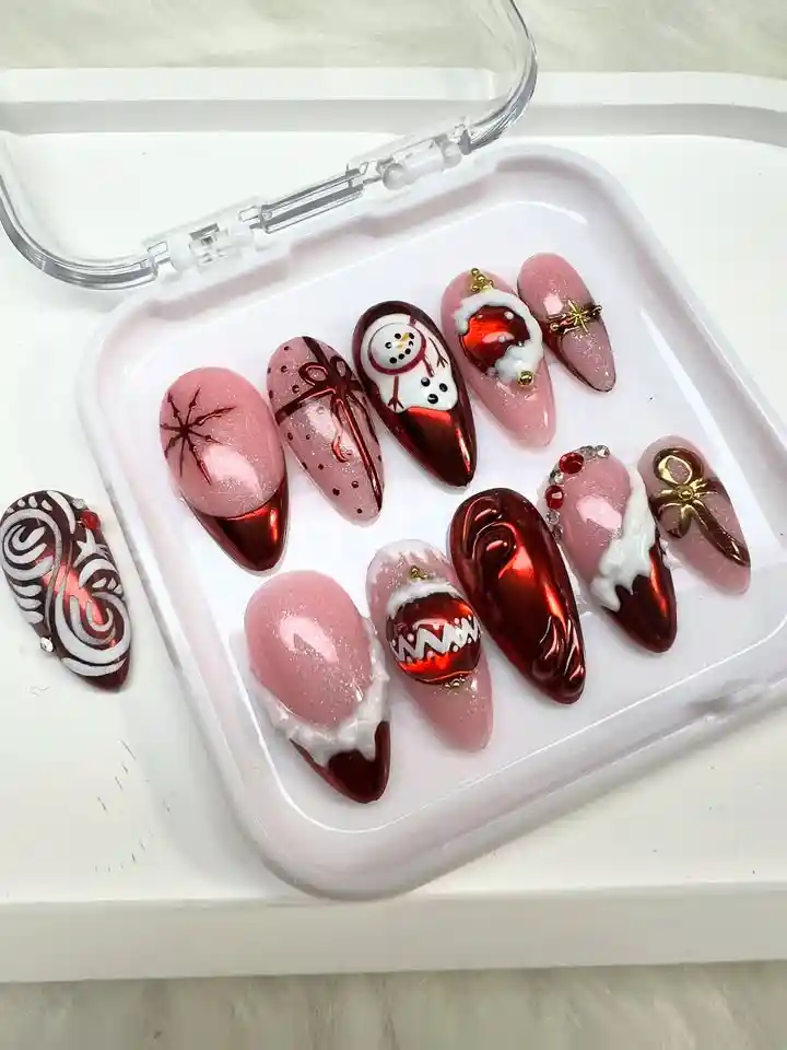 Case set with pink and deep red metallic-look tips plus a swirl-pattern extra tip