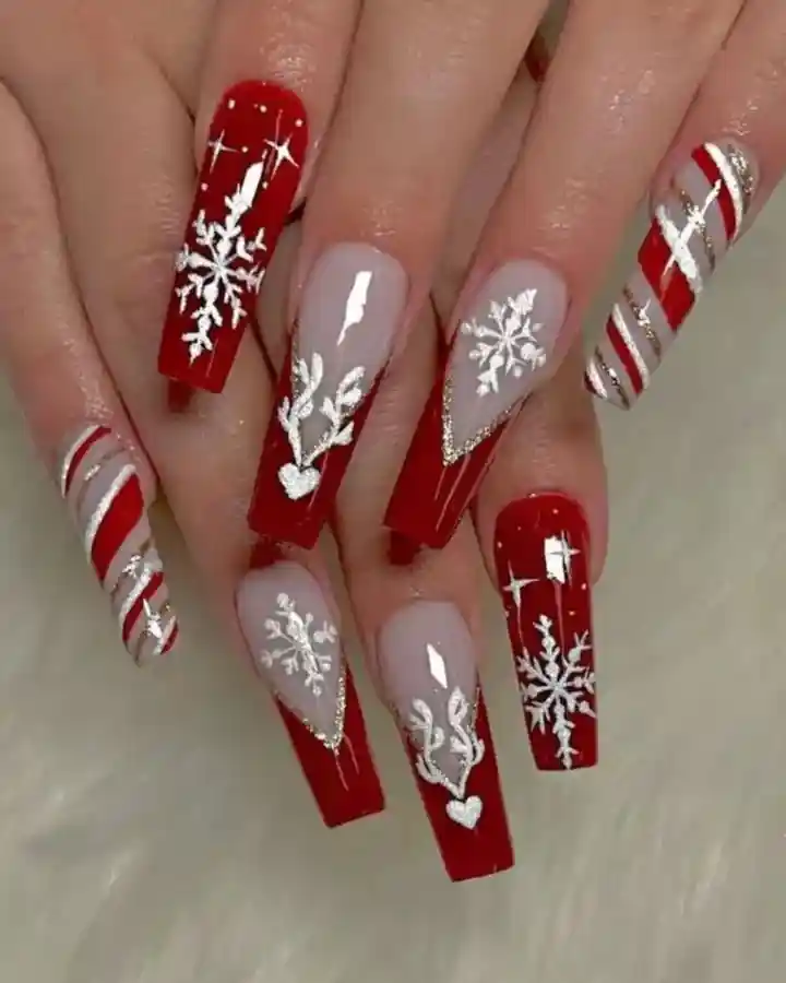 Long red and gray coffin nails with bold white snowflakes and silver accents
