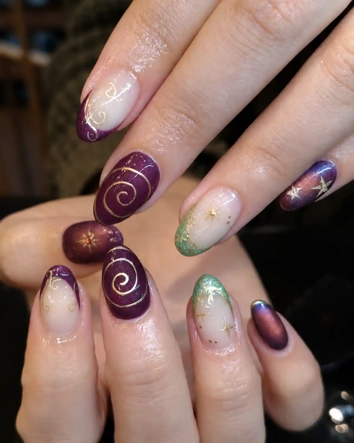 Shimmery deep purple with gold swirls and mixed glitter tips