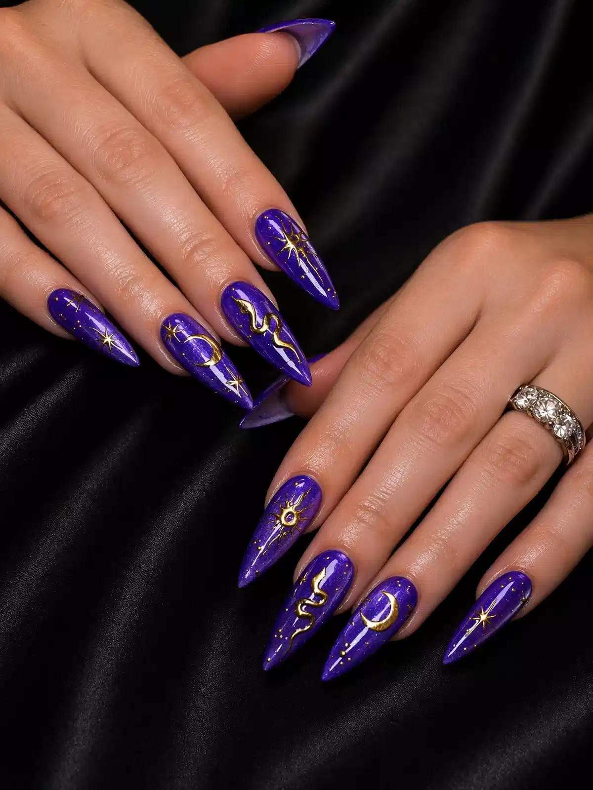 Long glossy purple stilettos with gold celestial motifs