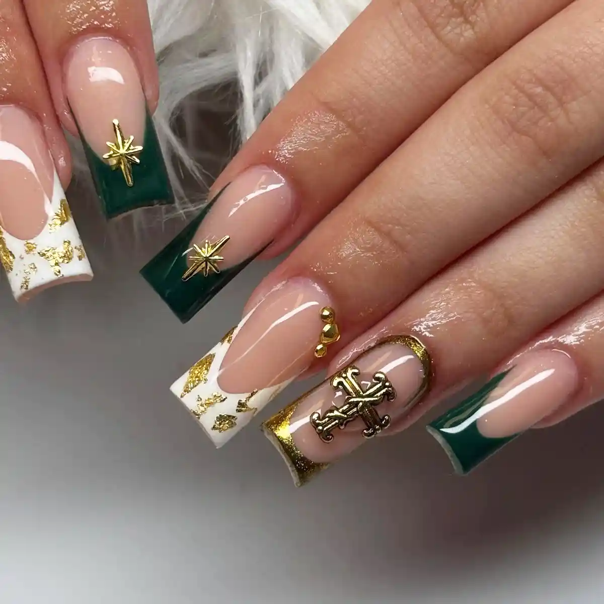 Green-tipped nails with gold nautical and star accents