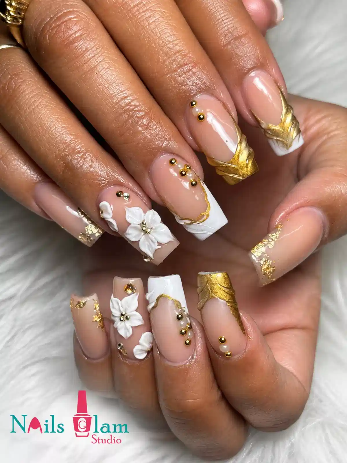 Nude and white nails with gold foil accents and 3D flowers