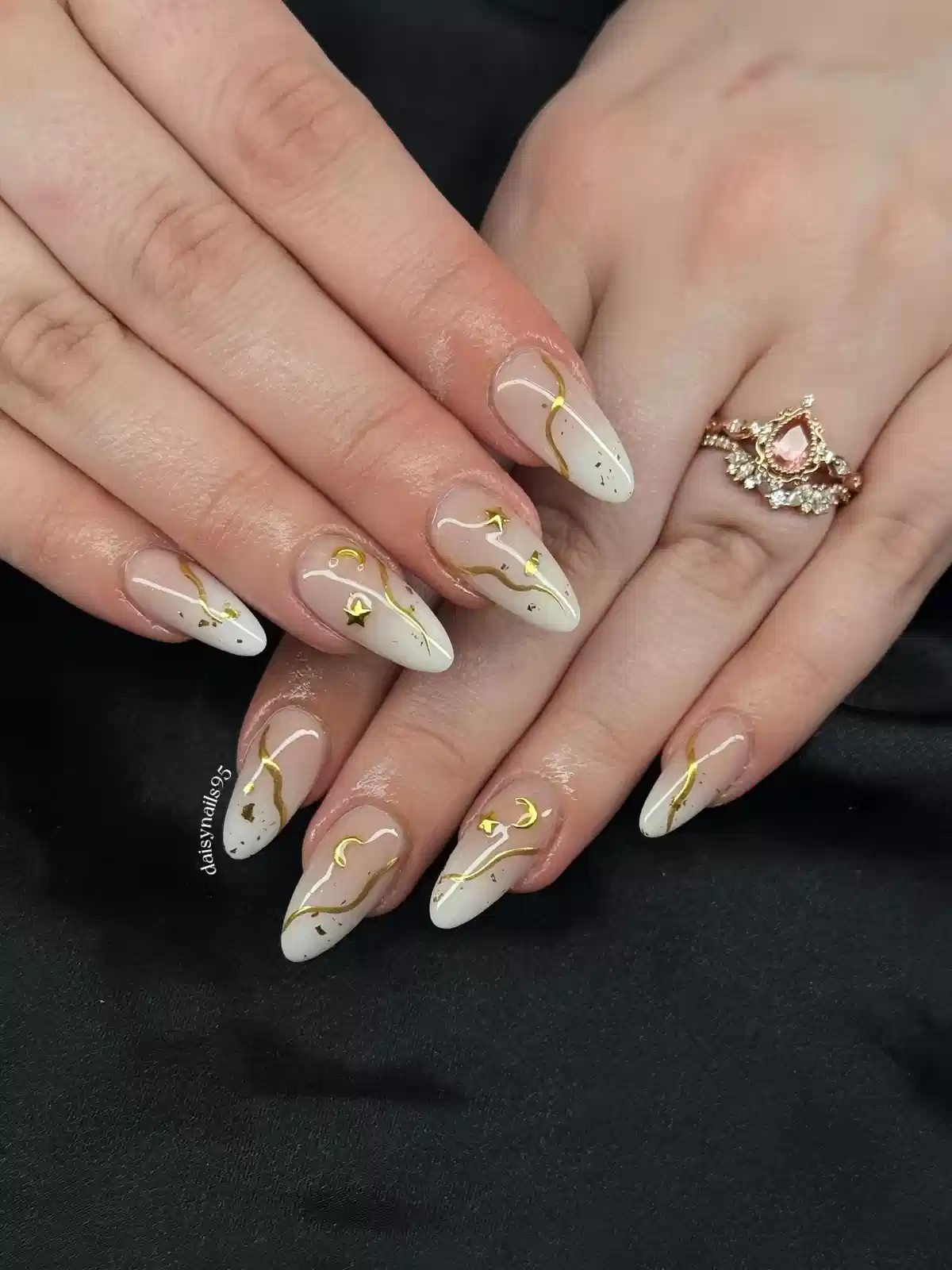 White-Tipped Almond Nails with Gold Waves, Stars, and Moons