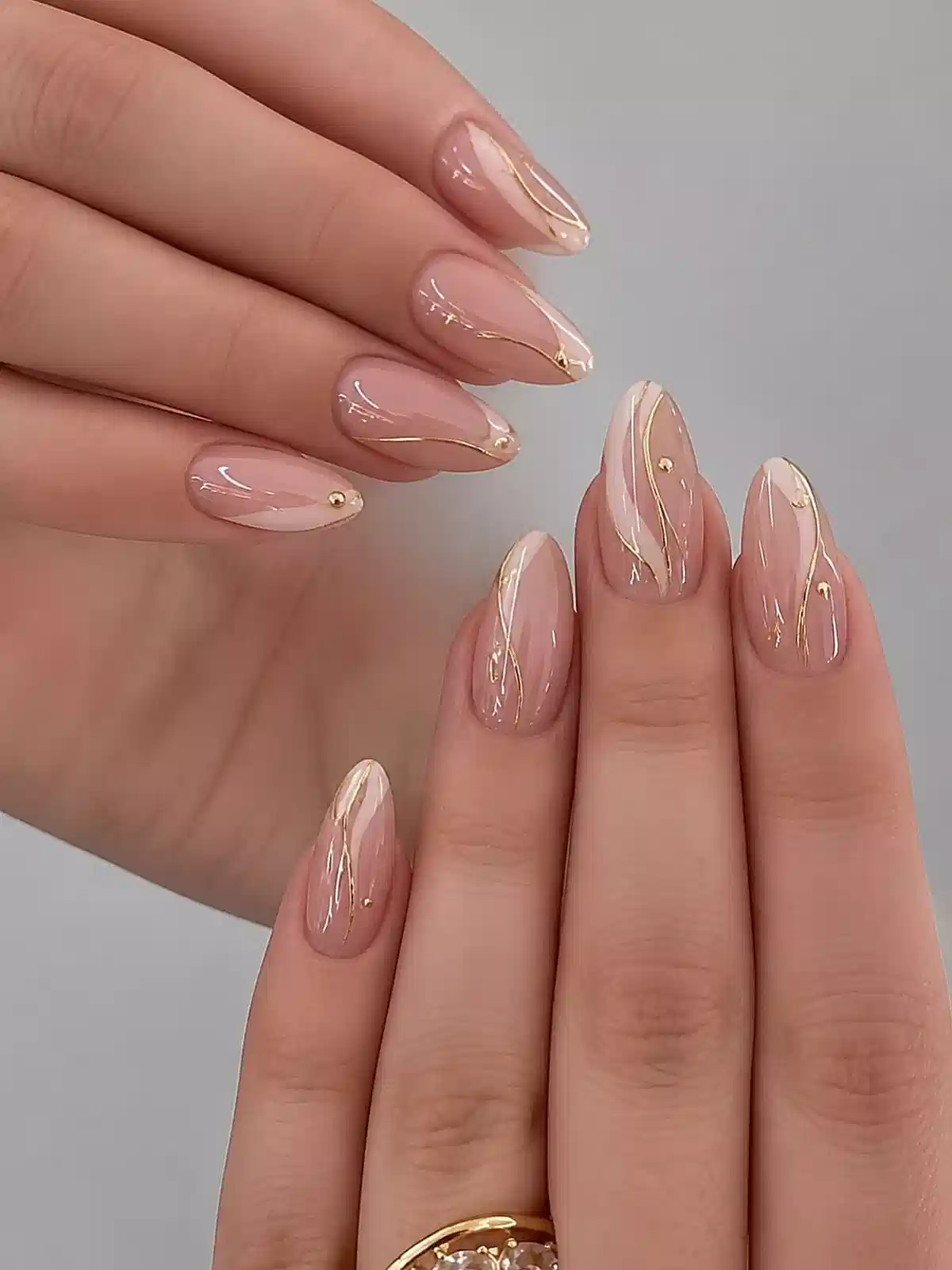 Minimal Nude Almond Nails with Fine Gold Lines and Studs
