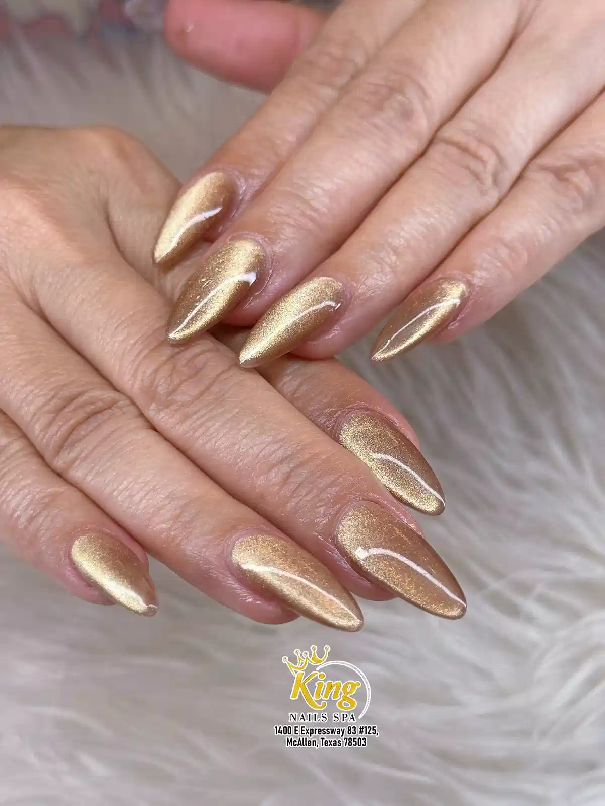 Glossy gold reflective nails with salon watermark