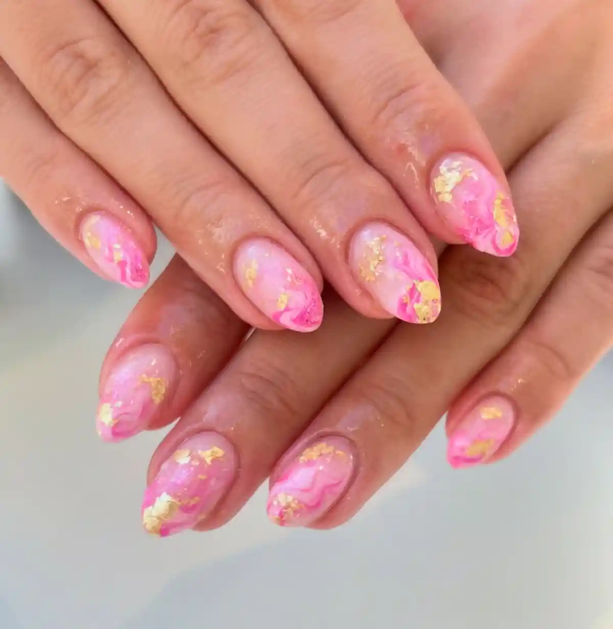 Pink marble swirls with scattered gold foil accents