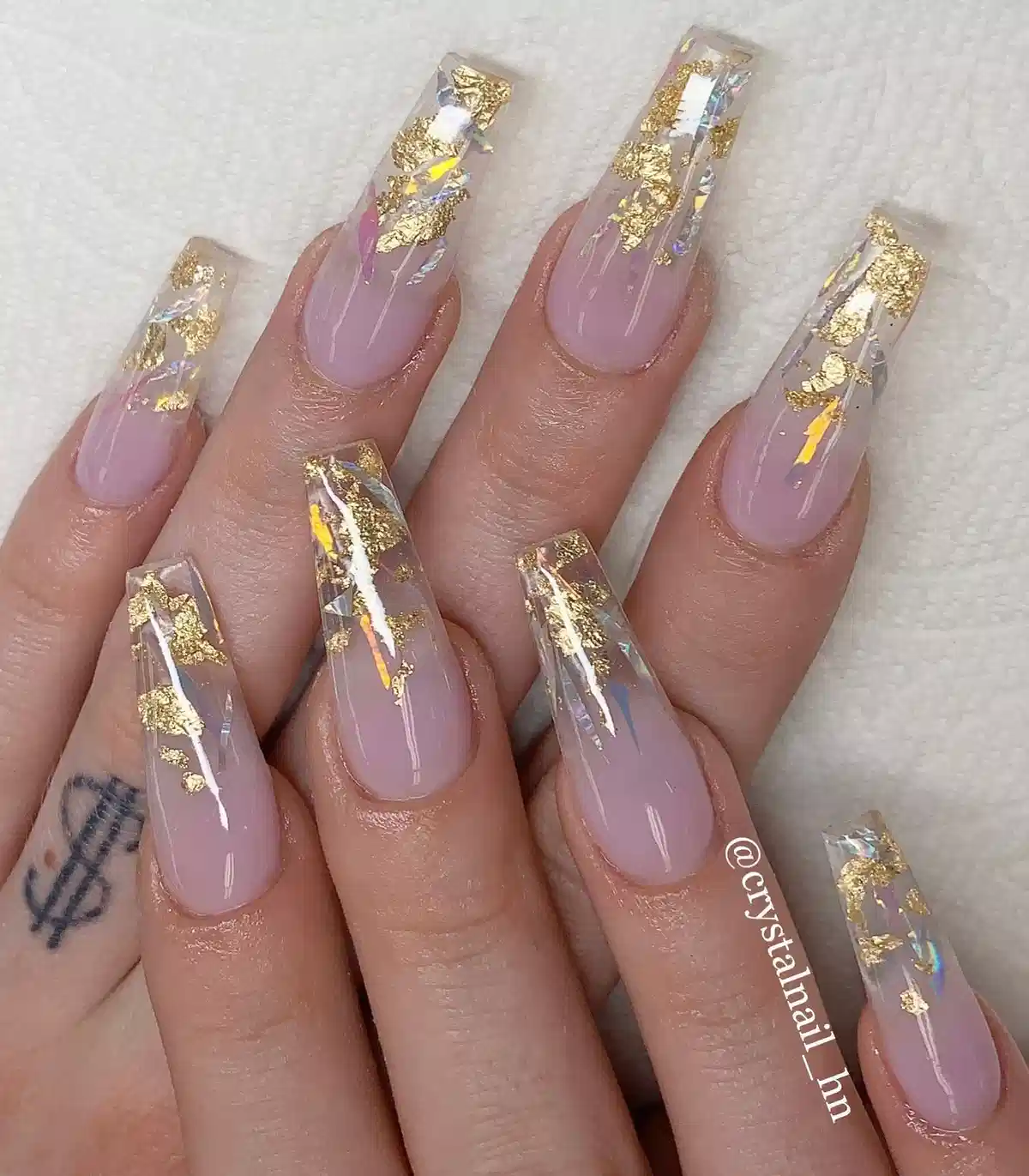 Long clear-tipped coffin nails with gold pieces and iridescent shards