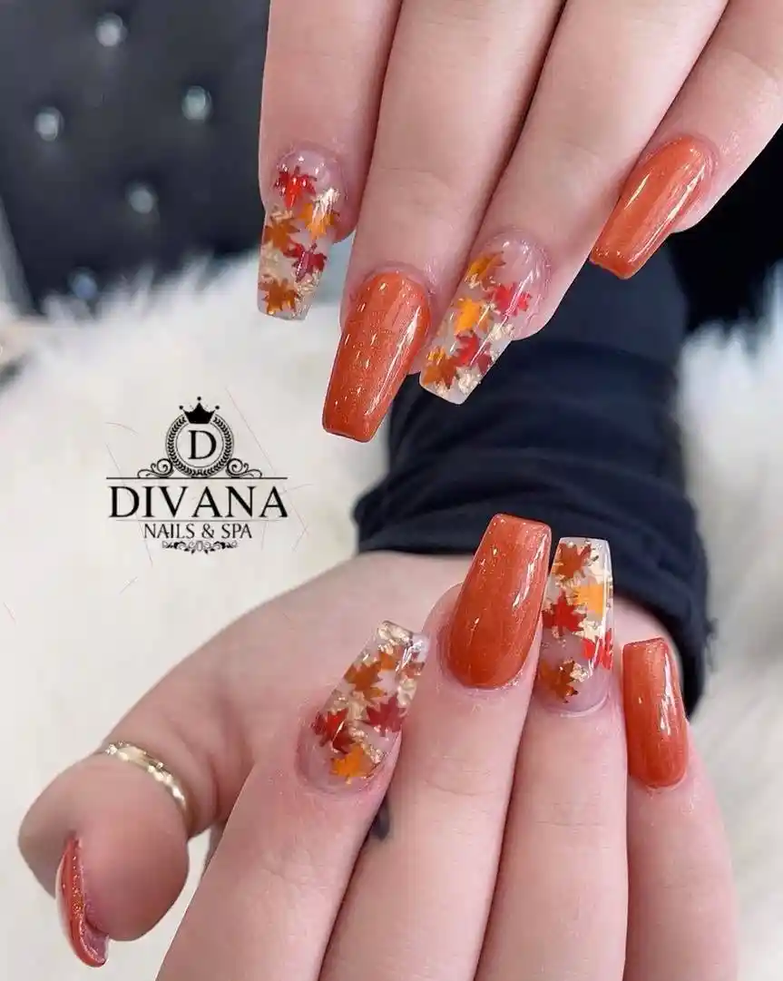 Burnt orange shimmer with clear nails featuring leaf confetti