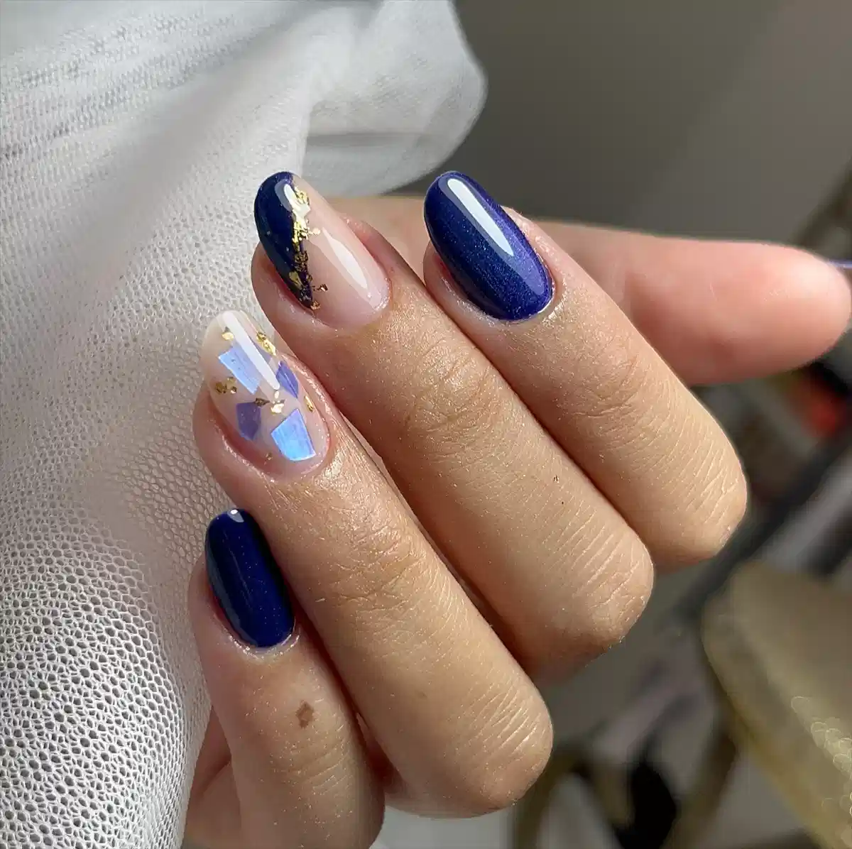 Deep blue solids with nude accents, gold pieces, and iridescent shapes