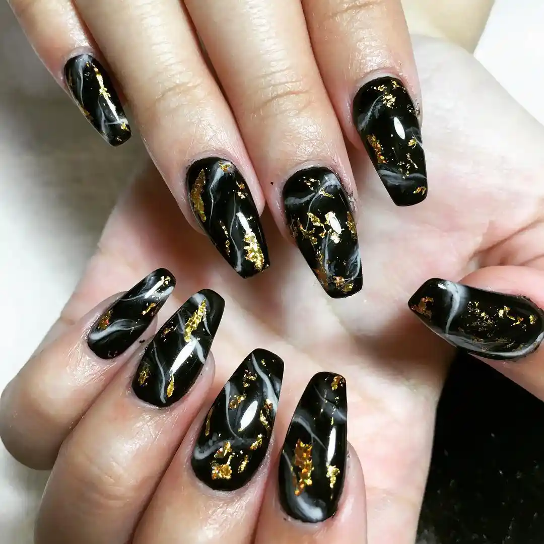Black marble coffins with scattered gold foil