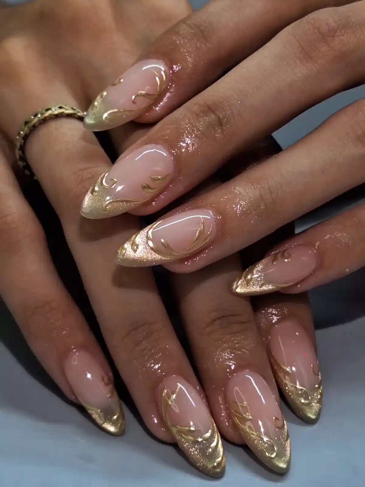 Gold glitter French tips with gold swirl linework