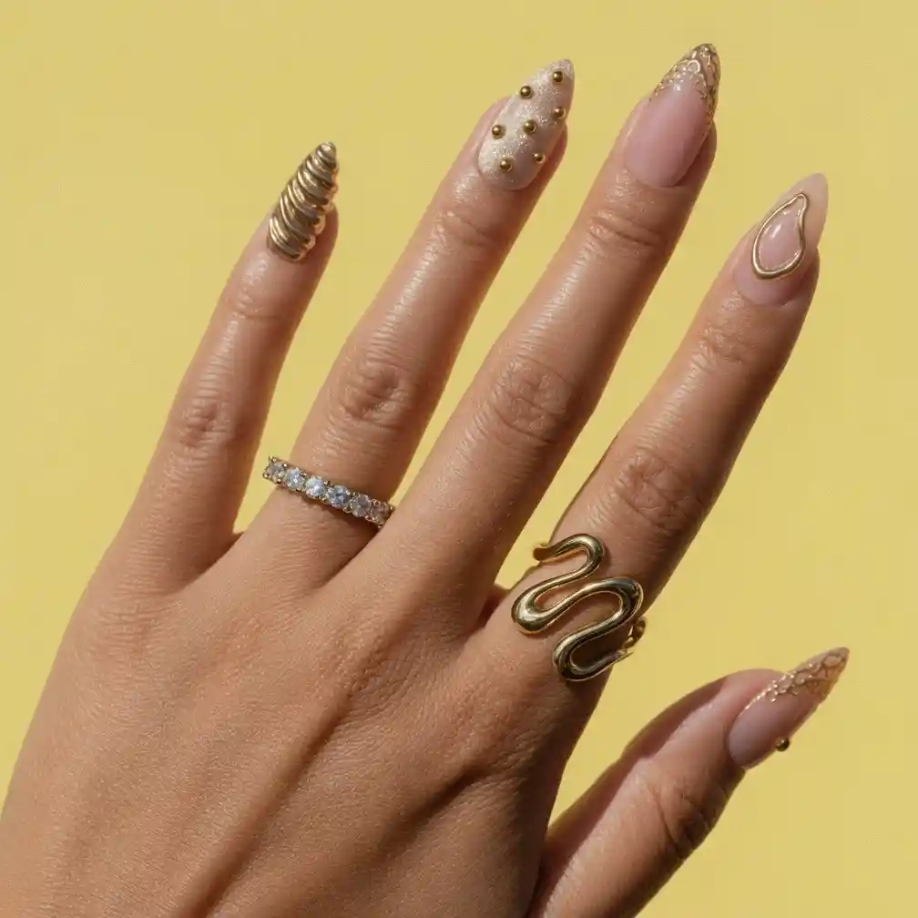 Gold textured accent nail with nude-and-gold outlines