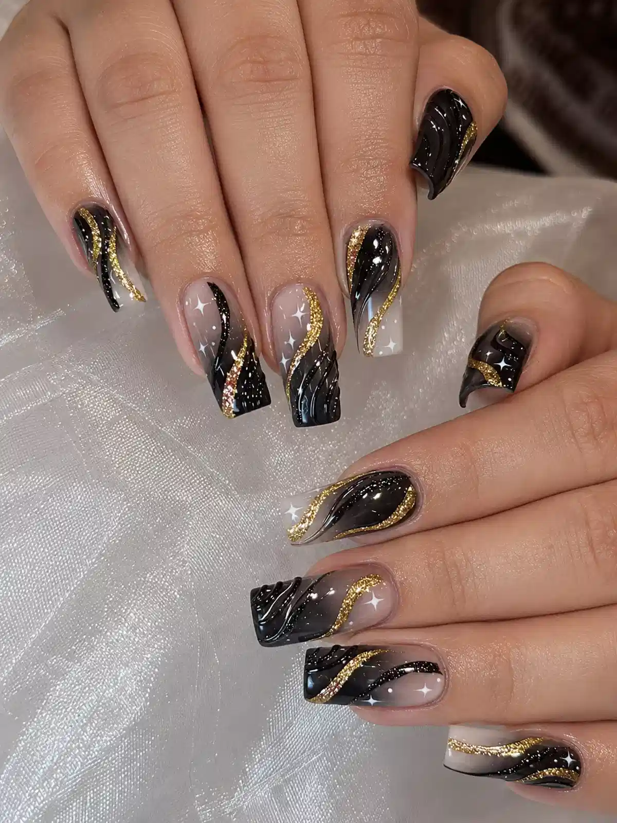 Black-and-nude waves with gold glitter curves
