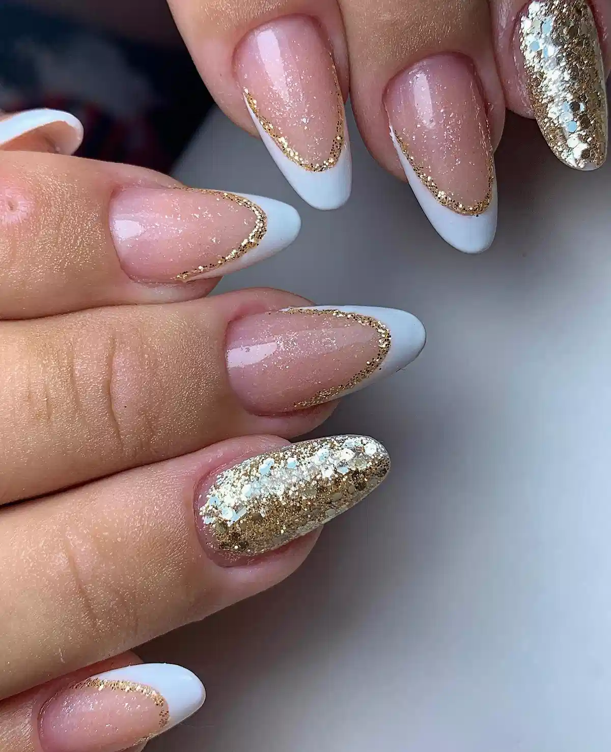 White French tips edged in gold glitter