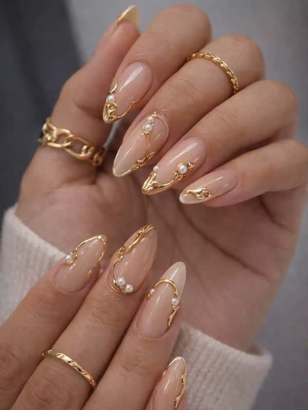 Sheer nude almonds with raised gold outlines and pearl accents