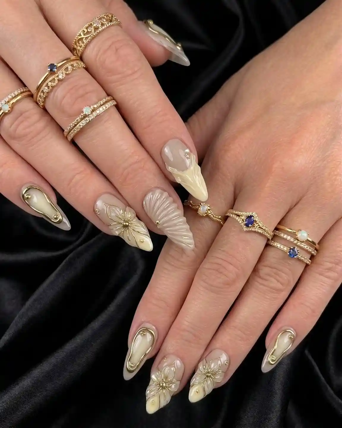 Cream nails with raised floral details and gold accents