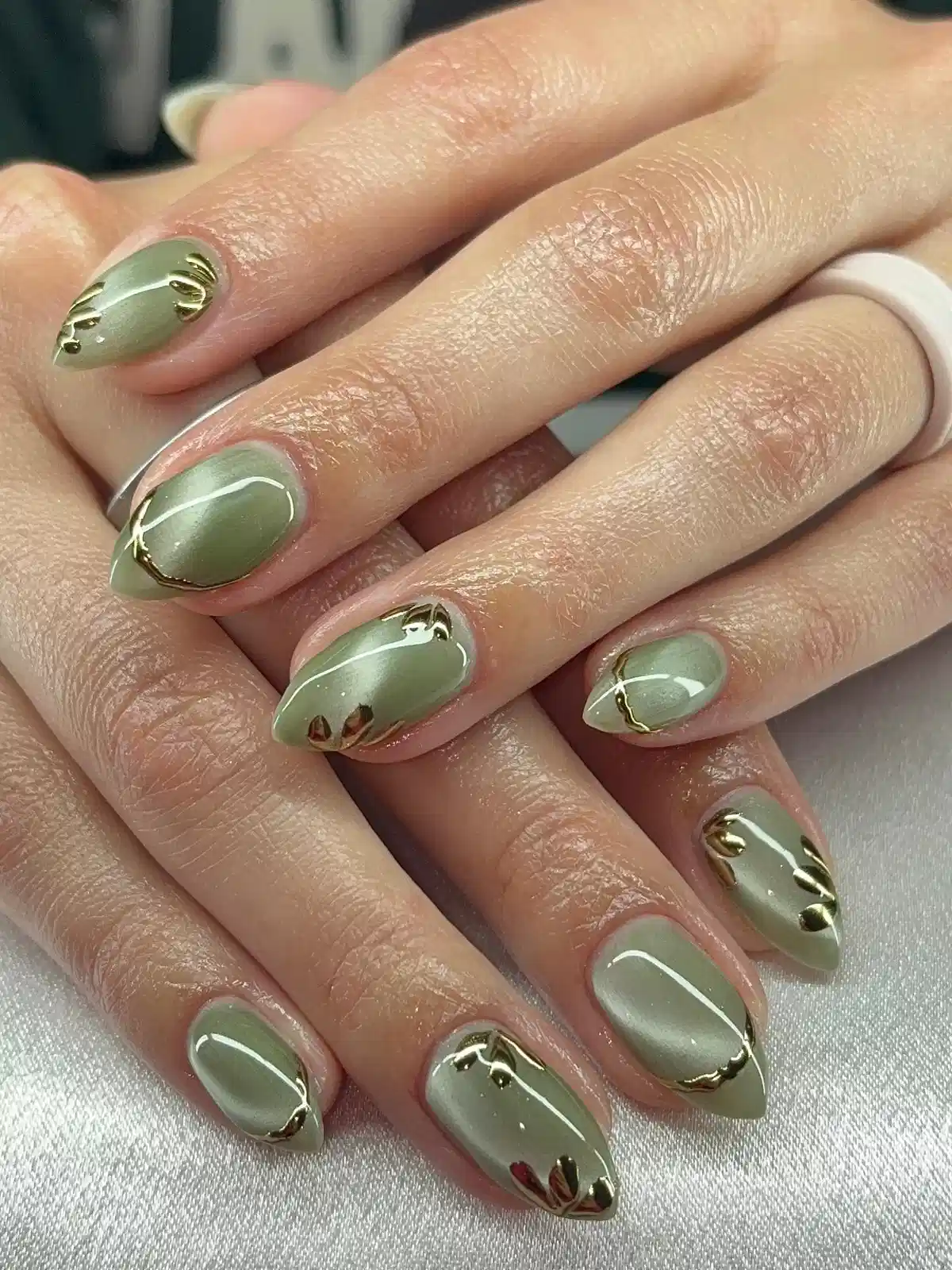 Sage green with gold curves and small leaf motifs