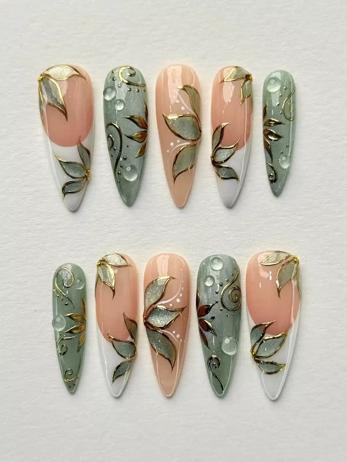 Nude and muted green press-ons with gold leaf line art