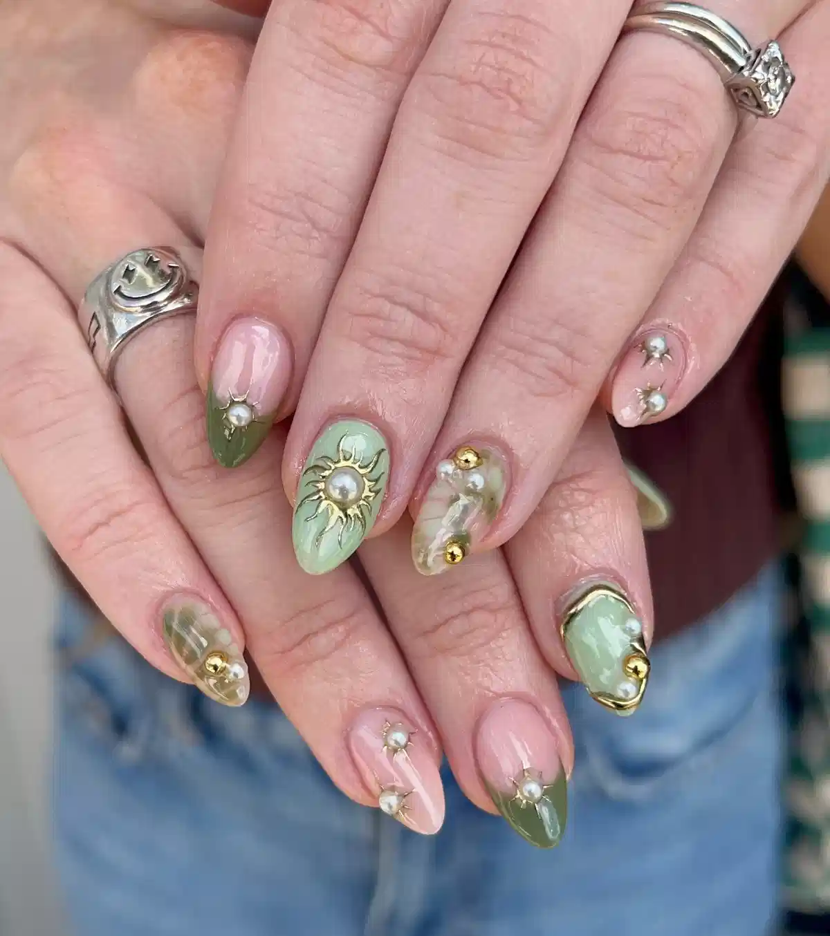 Green tips with pearl studs and sunburst accents