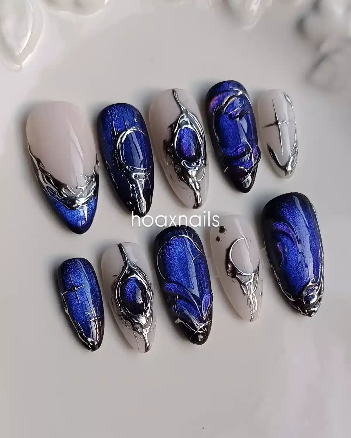 Cobalt blue and gray nails with raised silver sculptural accents