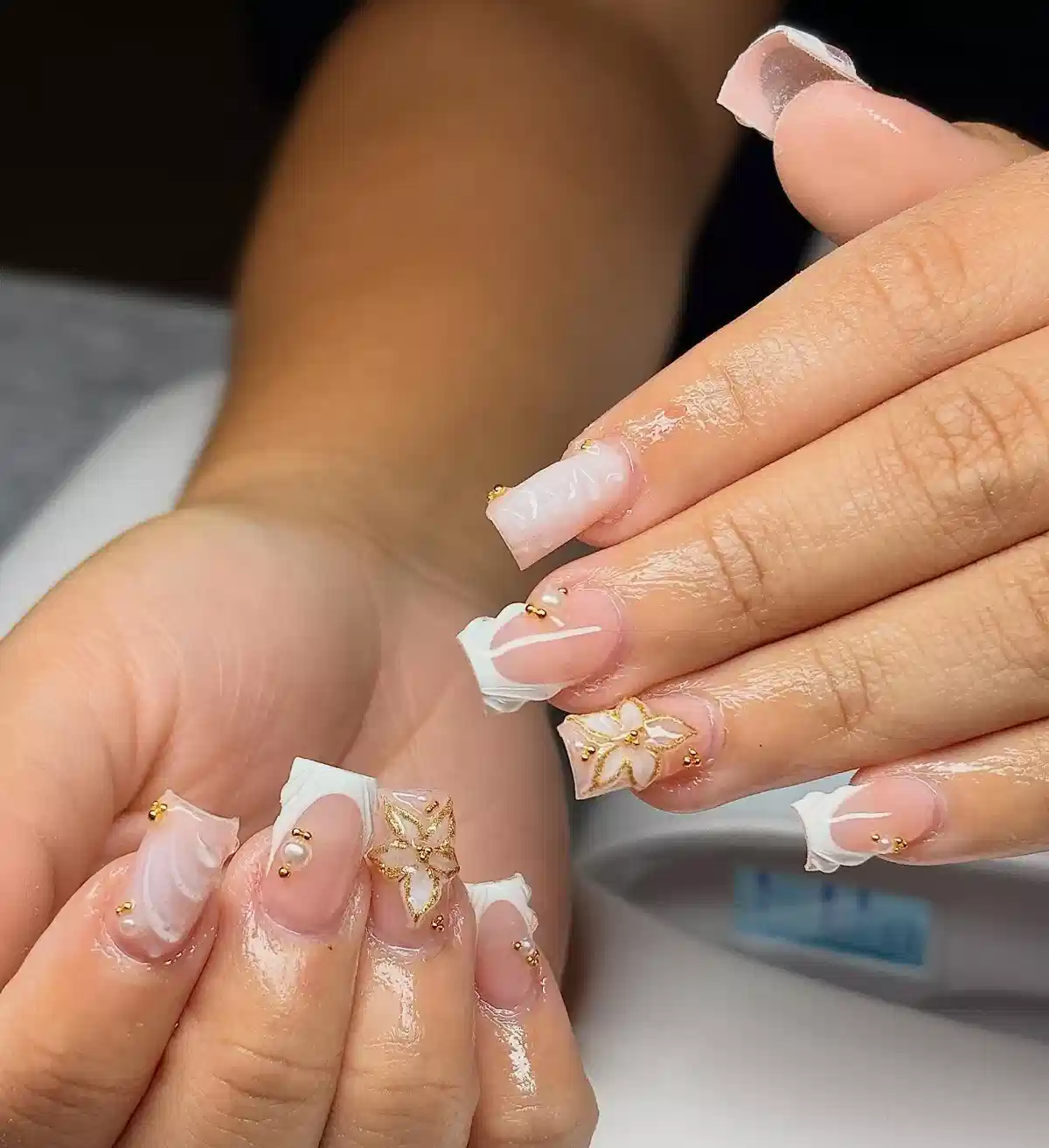 Square French tips with gold floral line art and stud accents