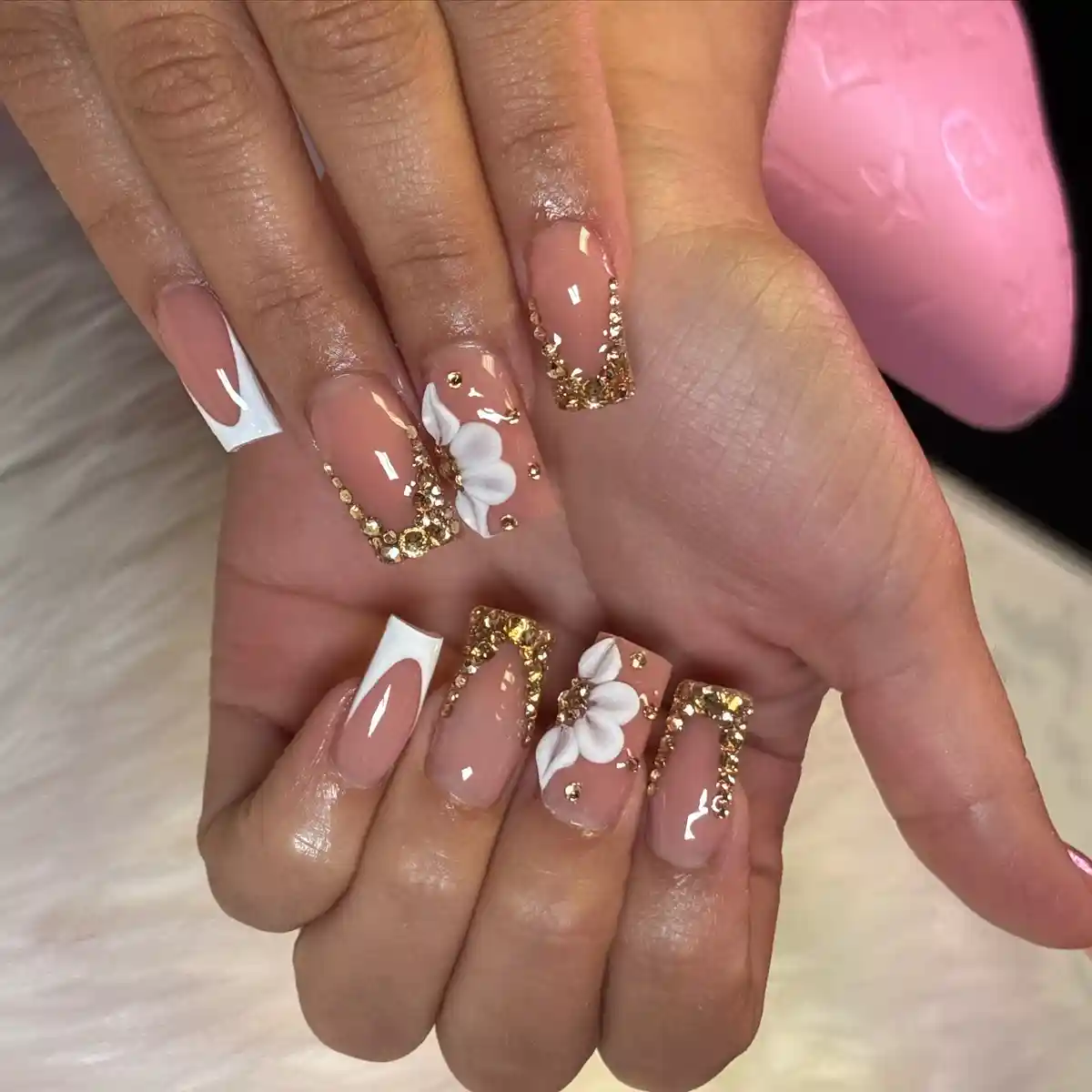 Nude square nails with gold crystal borders and raised white flowers