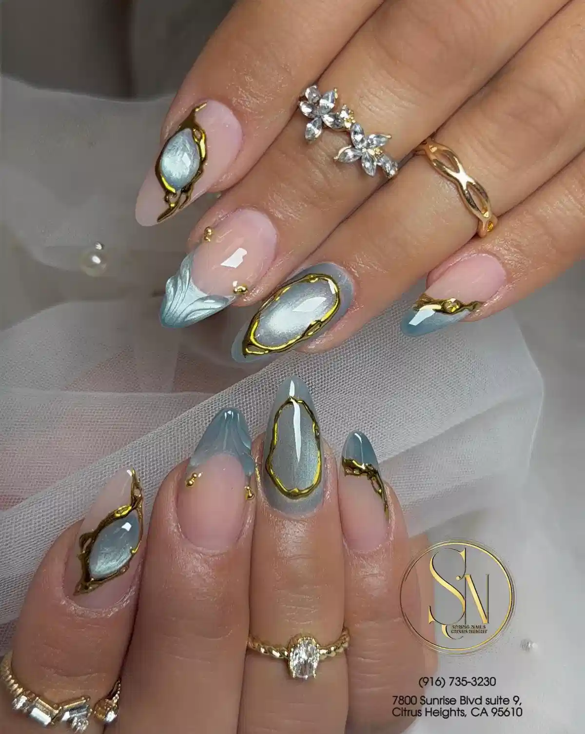 Nude base with silver ovals, gold frames, and pale blue accents