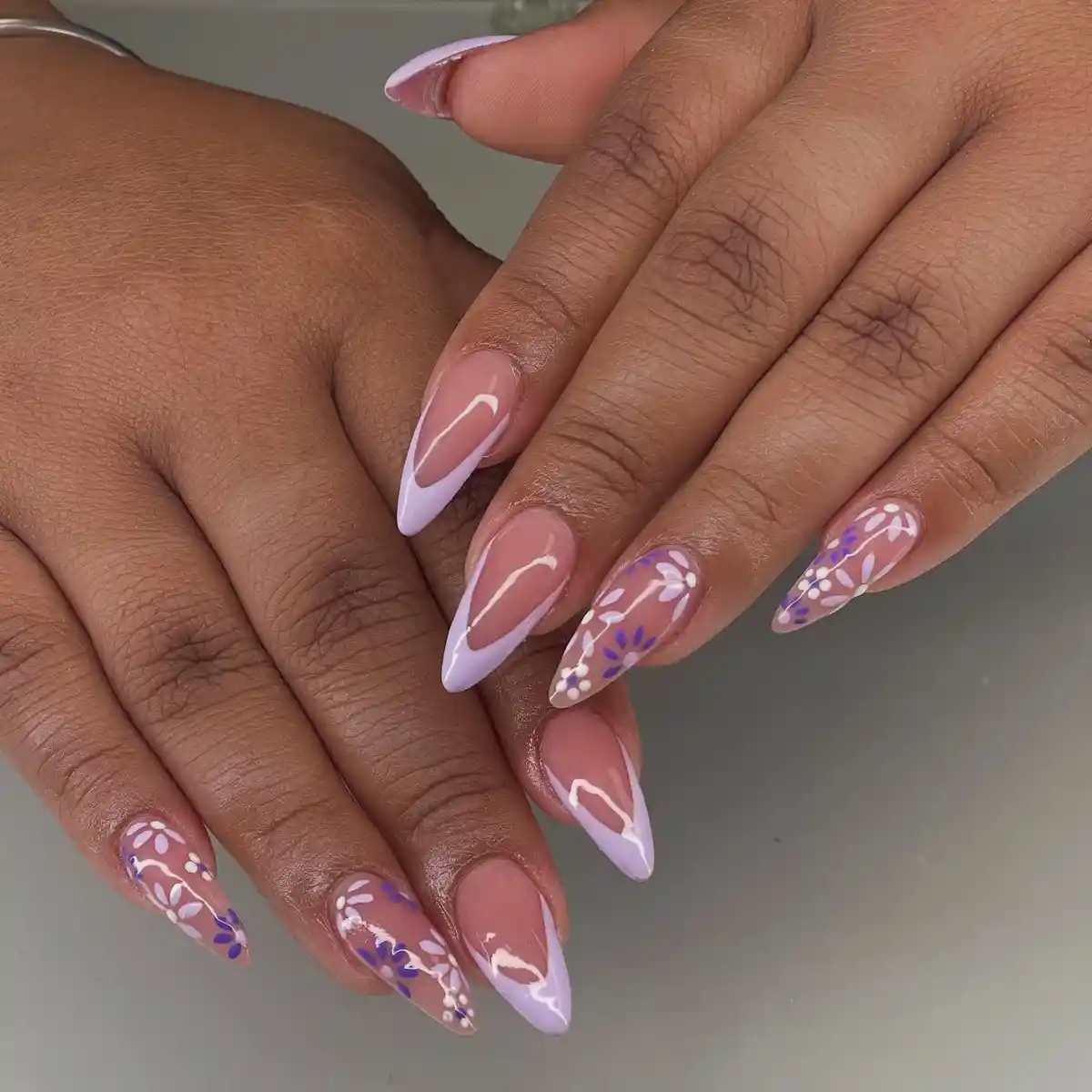 Nude-and-lavender French tips with floral line art