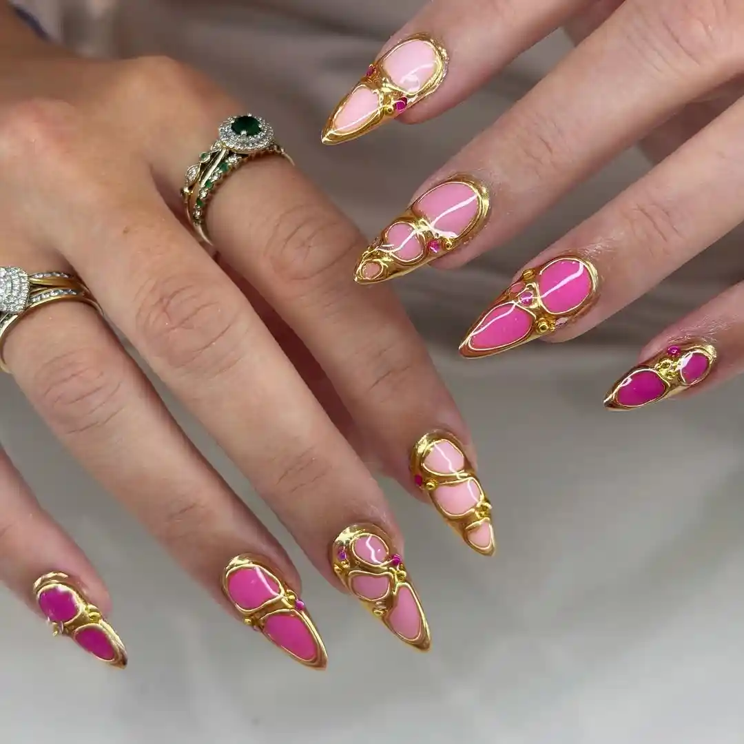 Stiletto pink nails with raised gold outlines