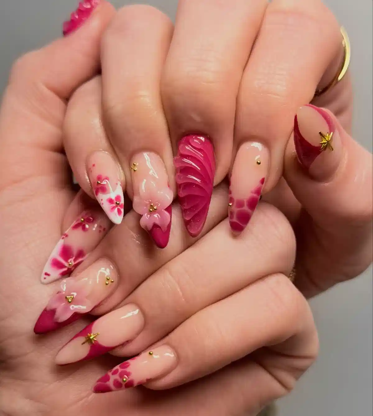 Mixed pink florals, studs, and textured accent nail