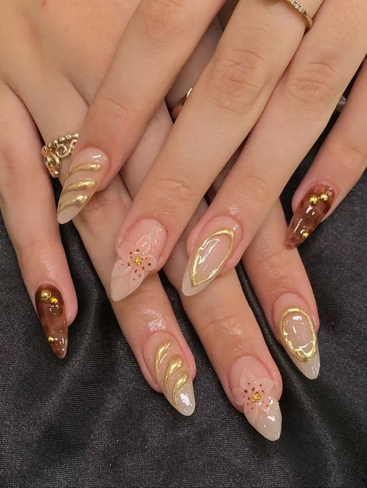 Nude, gold swirls, and brown marble accents